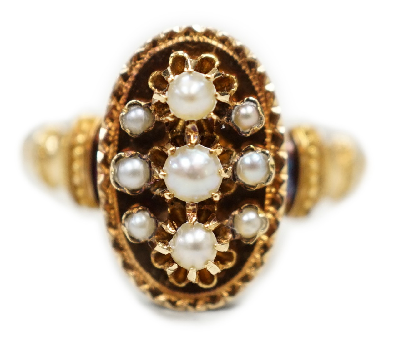 An early 20trh century French yellow metal (18ct poincon mark) and seed pearl cluster set oval ring, size N, gross weight 2.1 grams.